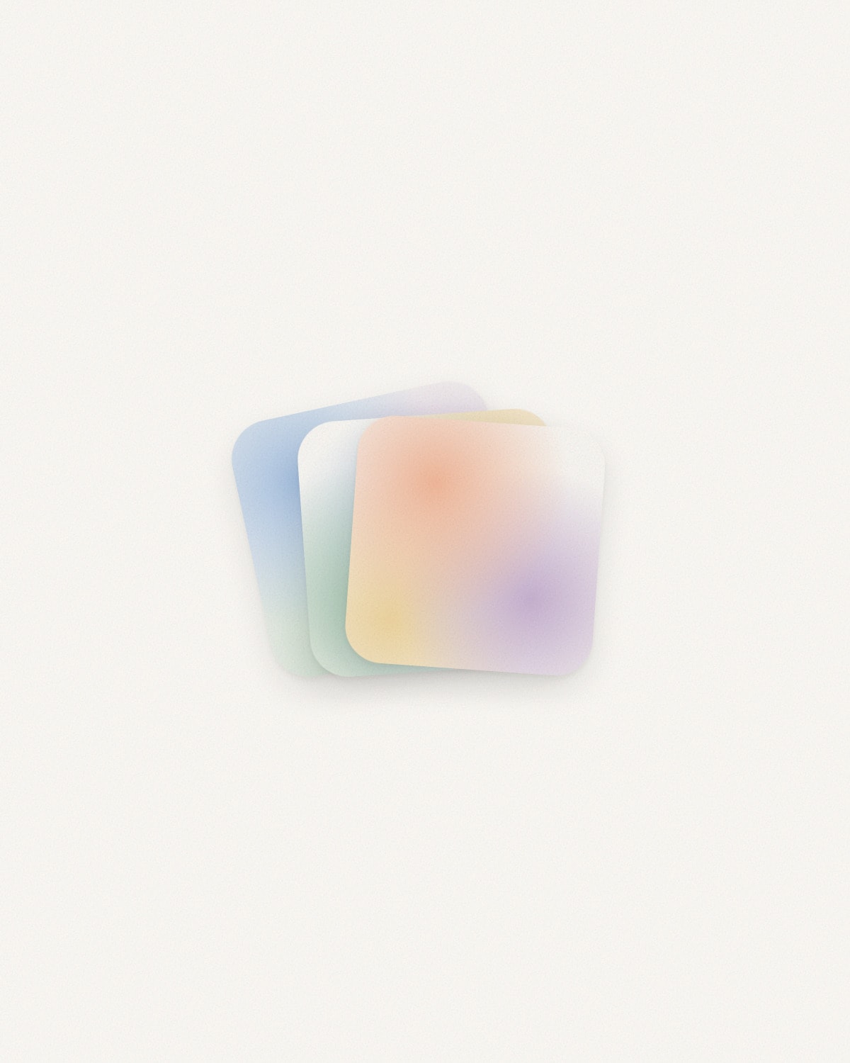 Pattern Creator on opening: three rounded tiles fanned out on a bone-white ground, each a soft cloud of colour — blue, green, and an orange, yellow and violet one in front.